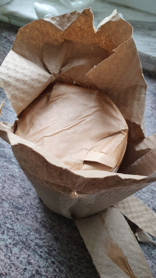 Unboxing: paper wrapping around a cardboard cylinder sealed with paper tape. Photo: ©Seas & Straws