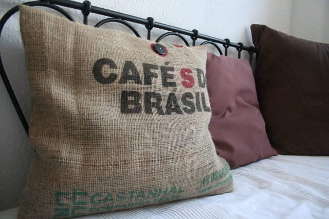 A couch pillow covered in an old burlap coffee sack- Photo: Seas & Straws